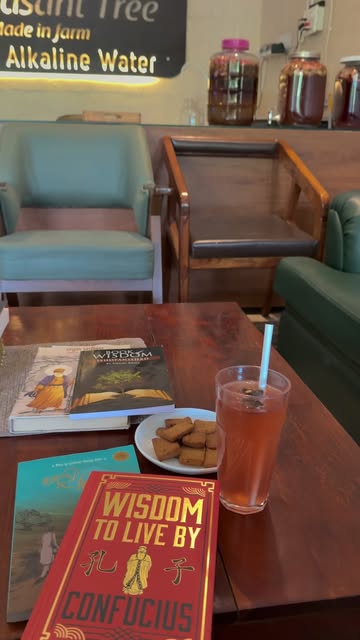 A drink, biscuits and books on the café reading table